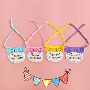 Detail of colorful Happy Birthday embroidery on soft fabric pet bibs in four colors