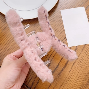 Pink plush hair claw clip for women featuring fuzzy texture and sturdy plastic teeth