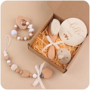 Handmade beech wood baby gift set with pacifier chain, wooden rattle, and milestone card