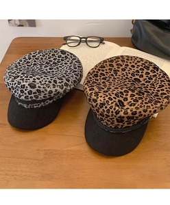 Detailed close-up of leopard print octagonal hats in grey and brown wool texture