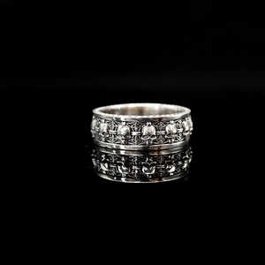 Detailed macro view of vintage S925 silver skull ring with punk gothic engravings
