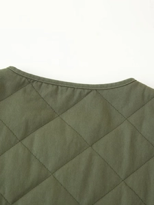 Detail shot of army green quilted jacket neckline featuring diamond stitching and twill texture