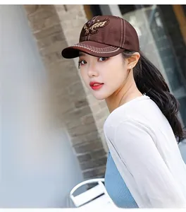 Detailed close-up of brown twill cotton baseball cap with eagle embroidery and stars