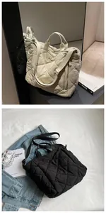 Detail view of the side zipper pocket and quilted texture on the nylon tote bag