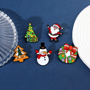 Set of five festive metal enamel pins with Santa Claus, Snowman, and Christmas tree