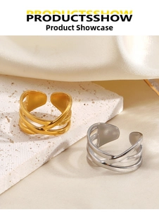 Detailed close-up of overlapping geometric criss-cross rings in gold and silver finish