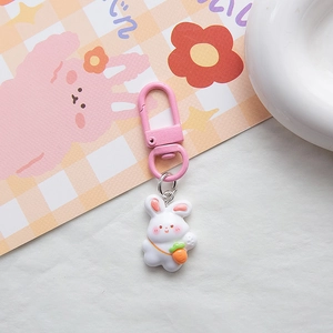 Close-up of cute white resin rabbit keychain with carrot and pink D-ring hook clasp