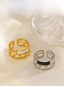 Detail of adjustable chain rings with black and white enamel in gold and silver finishes