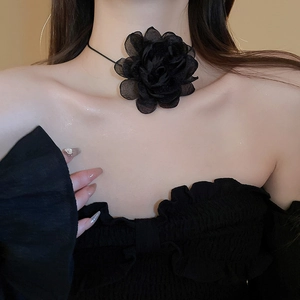 Close-up of a black mesh fabric flower choker necklace on a model's neck for a trendy look