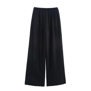 Macro shot of smooth black linen wide-leg pants with silky texture and drape