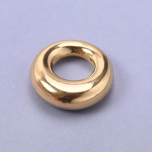 Detailed macro view of a polished 304 stainless steel oval gold pendant for DIY jewelry