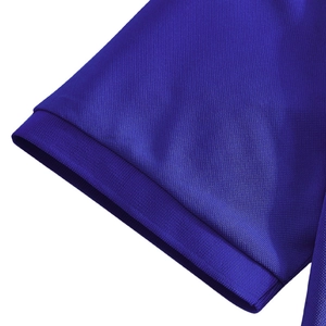 Detailed close-up of blue polo shirt ribbed cuff and breathable pique knit fabric texture