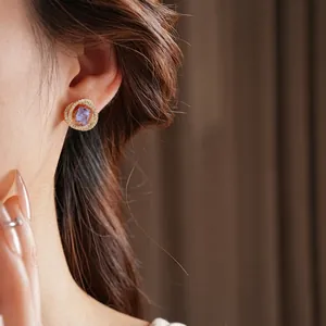 Square purple zircon earrings with gold micro-pave crystals on an Asian model