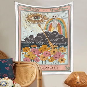 Detail of tarot tapestry with skeleton and rainbow patterns hung above a rattan chair