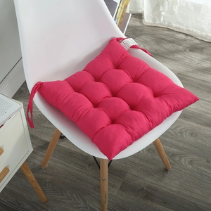 Detail of rose red quilted chair pad with anti-slip ties and soft polyester fabric