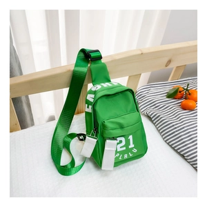 Détail du sac de poitrine enfant en nylon vert avec lettrage blanc et sangle ajustable