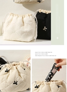 Quilted cosmetic bag detail showing soft fabric texture, bow embroidery, and drawstring closure.