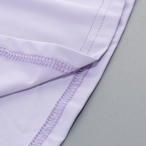 Detail view of lavender knitted dress featuring professional stitching and ribbed texture