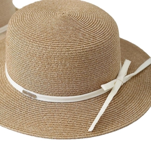 Handcrafted Raffia straw sun hat with elegant beige ribbon and a bow decoration