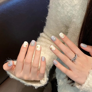 Handmade press-on nails with gold star and moon totems in grey and cream bohemian style