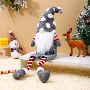 Detail of Christmas long-legged gnome plush with knit hat and striped socks on a shelf
