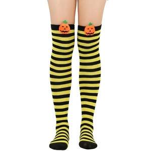 Detail of Halloween over-the-knee socks with yellow stripes and 3D pumpkin dolls