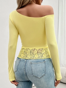 Detailed view of yellow off-shoulder top featuring lace patchwork on the back and sleeve