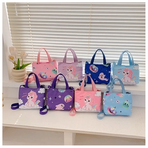 Multiple colorful unicorn and star pattern children's canvas bags on a white shelf