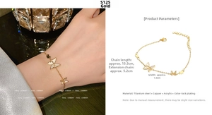 Detail view of golden butterfly bracelet with adjustable chain and sparkling charms