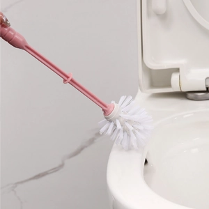 Pink long handle toilet brush with soft white bristles and holder for bathroom cleaning