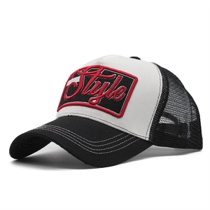 Close-up of 3D Style embroidery on black and white mesh trucker hat with decorative stitching