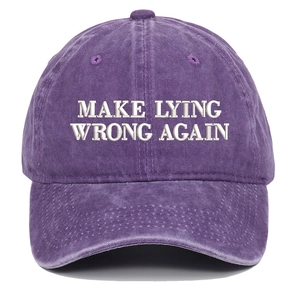 Close-up of white embroidery on purple washed cotton vintage baseball cap texture