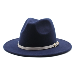 Detail of navy blue wool fedora hat featuring a light grey leather band and gold buckle
