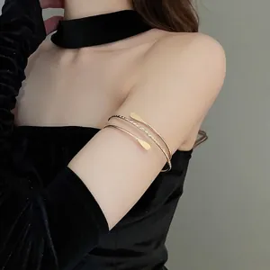 Minimalist multi-layered golden arm cuff bracelet with elegant textured spiral design