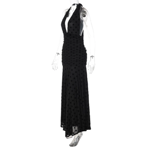 Detail of black polka dot mesh maxi dress with halter neck and backless design