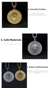 Macro detail of gold and silver lion head pendants with sparkling crystal border and twisted chain