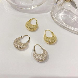 Elegant gold and silver brass croissant earrings with micro-set zircons on a minimal base