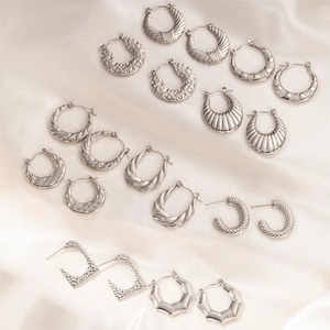 Detailed set of silver stainless steel earrings featuring croissant and twisted designs