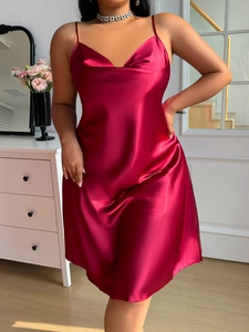 Detail of burgundy silk satin slip dress with thin straps and cowl neck design