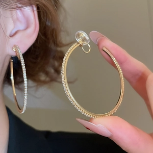 Detail of gold crystal hoop earrings featuring soft silicone pads for comfort clip-on wear