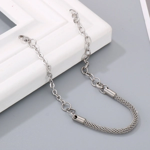 Close-up of silver stainless steel woven mesh and link chain bracelet on a white frame