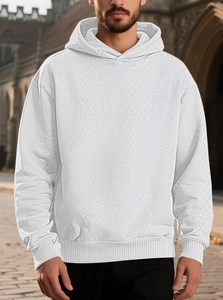 Detail of white men's hoodie showing unique waffle weave texture and casual knitted fabric