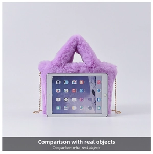 Close-up of purple faux rabbit fur handbag with golden chain strap next to an iPad