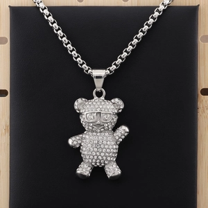 Detailed close-up of a silver panda pendant encrusted with sparkling crystals and glasses