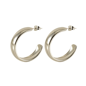 Macro detail of silver-toned C-shaped chunky hoop earrings in polished stainless steel