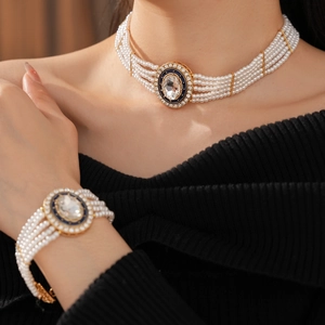 Detail of vintage multi-layer pearl necklace and bracelet set with blue enamel pendant
