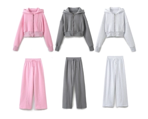 Flat lay of women's lounge sets in pink and grey showing hoodies and wide-leg joggers