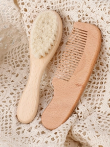 Close-up of baby hairbrush set with soft wool bristles and natural beechwood handles