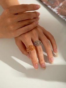 Close-up of filigree vintage titanium steel rings in gold and silver finish for women