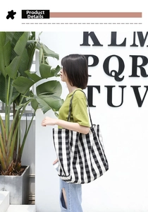 Detail of checkered canvas tote bag with long shoulder straps for casual outdoor styling